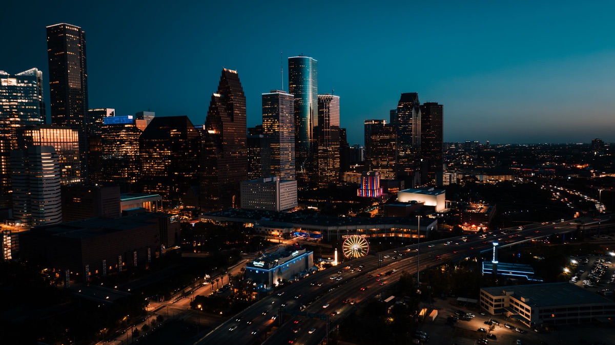 Downtown Houston at night with freeway light trails in the foreground