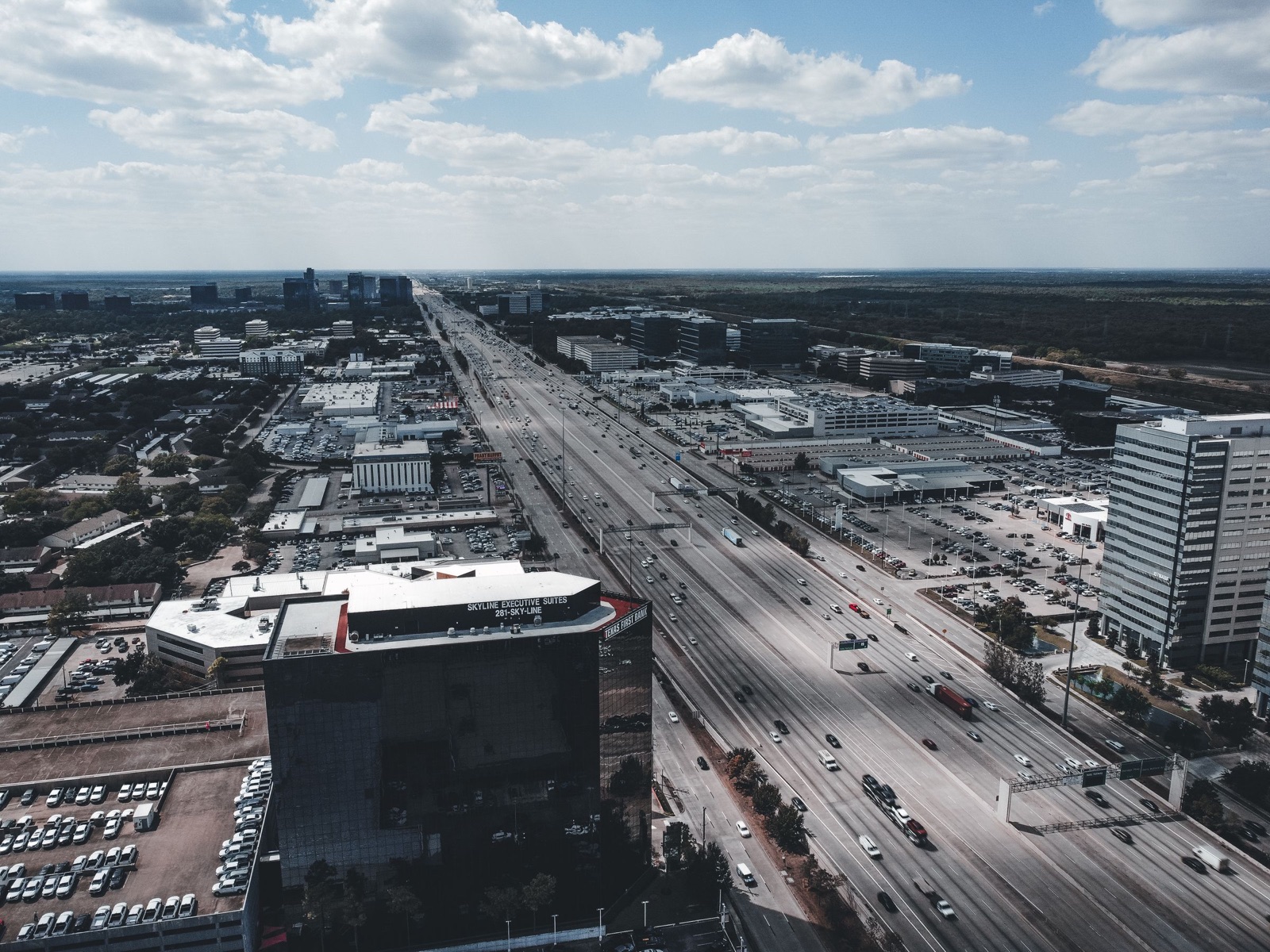 Aerial photograph of a Houston freeway and surrounding commercial blocks